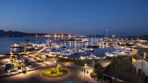 a marina at night with boats in the water at Il Mirto apartment con piscina in Olbia +5 photos