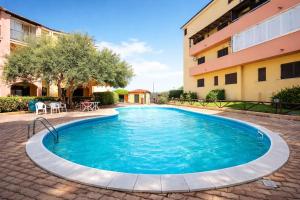 a swimming pool in front of a building at Il Mirto apartment con piscina in Olbia