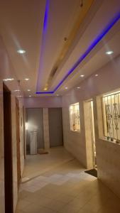a room with a blue light on the ceiling at studio climatisé in Keur Massar