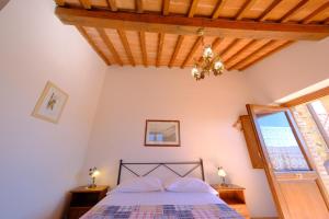 a bedroom with a bed and a wooden ceiling at Agriturismo Montegonfoli in San Gimignano +165 photos