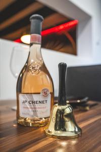 two bottles of wine sitting on a wooden table at La Cachette - Suite romantique & balnéo privative in Hermeray +22 photos