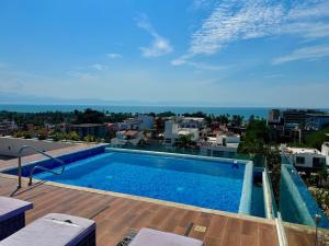 a swimming pool on the roof of a building at 2BR Condo with Ocean View near beach in Bucerías