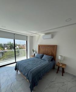 a bedroom with a bed and a large window at 2BR Condo with Ocean View near beach in Bucerías +13 photos