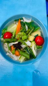 a blue bowl filled with vegetables on a blue table at Dhanrains La Rocha in Patnem +27 photos
