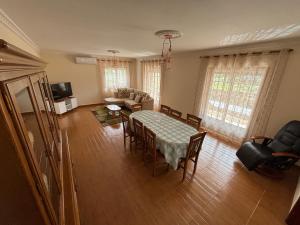 a living room with a table and chairs and a couch at Casa dos Neto Carriço in Anadia