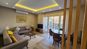 a living room with a couch and a table at Maison 7 New Cairo in Cairo