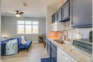 a kitchen with a sink and a bed in a room at Surfboard-Themed Huddleston Studio w/ Beach Access in Huddleston