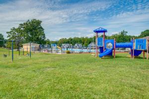 a playground with a blue slide in a field at Surfboard-Themed Huddleston Studio w/ Beach Access in Huddleston