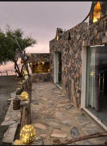 a stone building with a stone walkway at Balcony walk rest house Jabal shams in Sa‘ab Banī Khamīs +22 photos