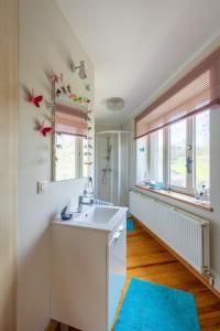 a bathroom with a sink and a mirror at Ferme du Banoyard in Theux +44 photos