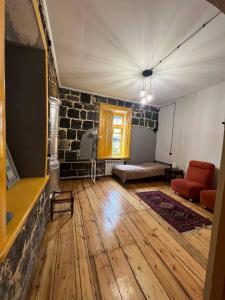 a living room with a couch and a tv at Green Vibe Guesthouse in Vanadzor