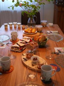 a wooden table with plates of food and cups on it at Hissele in Hilsenheim