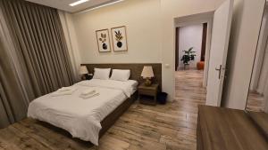 a bedroom with a large bed with white sheets at Maison 7 New Cairo in Cairo +118 photos