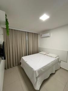 a bedroom with a white bed and a window at Seller Residence Centro in Sobral