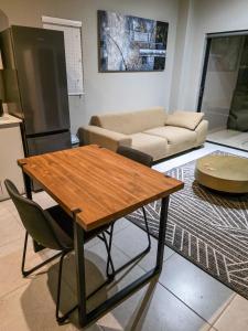 a living room with a table and a couch at West Coast Apartment 85 in Langebaan