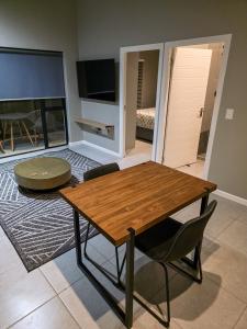 a living room with a wooden table and chairs at West Coast Apartment 85 in Langebaan
