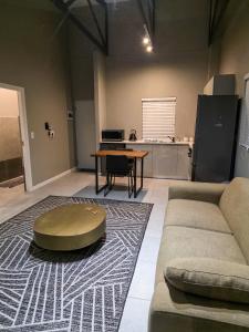 a living room with a couch and a table at West Coast Apartment 85 in Langebaan