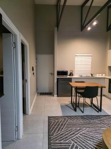a kitchen with a wooden table and a table sidx sidx sidx sidx at West Coast Apartment 85 in Langebaan +2 photos
