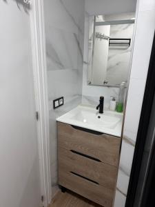 a bathroom with a sink and a mirror at Apartamento Torrenueva en playa 4 planta in Torrenueva +5 photos