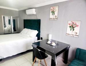 a hotel room with a desk and a bed at Kiba guest house in Marble Hall