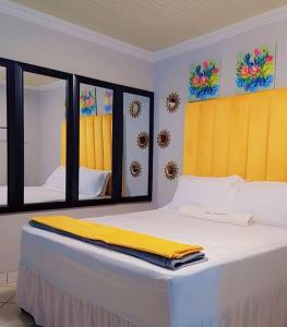 a bedroom with a bed with a yellow blanket on it at Kiba guest house in Marble Hall