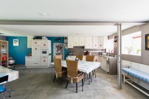 a kitchen with a table and chairs in a room at Ferme du Banoyard in Theux