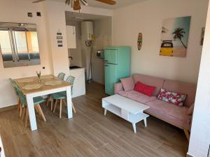 a living room with a couch and a table at Apartamento Torrenueva en playa 4 planta in Torrenueva