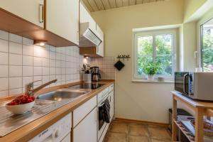 a kitchen with a sink and a counter top at Ferienhaus 4 in Fehmarn