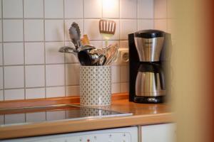 a kitchen counter with a container of kitchen utensils at Ferienhaus 4 in Fehmarn