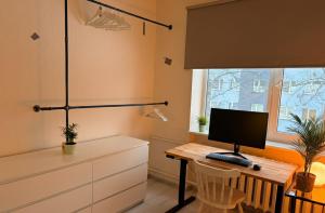 a room with a desk with a computer on it at Nice apartment close to the beach in Tallinn