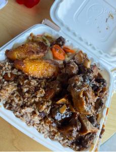 a plastic container of food with meat and rice at Caribbean Deck Estate in Effort +20 photos