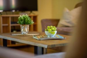 a coffee table with a bowl of grapes on it at Ferienhaus 3 in Fehmarn