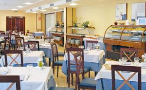a dining room filled with tables and chairs at Hotel RH Riviera - Adults Only in Gandía