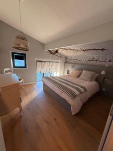 a bedroom with a large bed and a window at La P'tite Bicoque in Doizieux