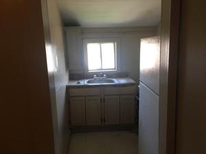 a small kitchen with a sink and a window at 424 E Levee Sreet #1 in Brownsville