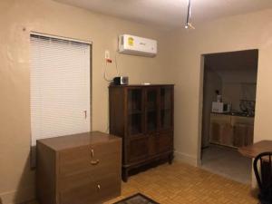 a living room with a dresser and a chest of drawers at 424 E Levee Sreet #1 in Brownsville