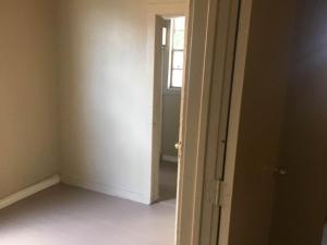 an empty room with a door and a window at 424 E Levee Sreet #1 in Brownsville