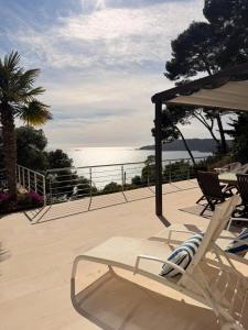 a pair of chairs and an umbrella on a patio at Blueview Villa in Llafranc