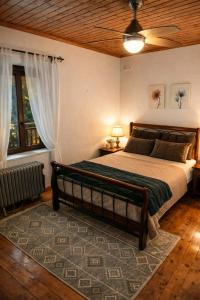 a bedroom with a large bed with a ceiling at Alma-Maroon Klara & Rachel in Drymon