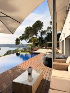 a patio with a table and a view of the water at Blueview Villa in Llafranc
