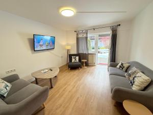 a living room with two couches and a table at Ferienhaus Frei 4 Compact in Hinterzarten