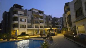 a courtyard with a pool in front of a building at Maison 7 New Cairo in Cairo