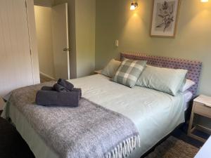 a bedroom with a bed with a pillow on it at Property close to the beach in Nelson