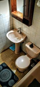 a bathroom with a toilet and a sink at La Casa de los Cactus in Coquimbo +83 photos