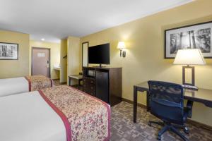 a hotel room with two beds and a desk with a computer at Best Western Blackfoot Inn in Blackfoot
