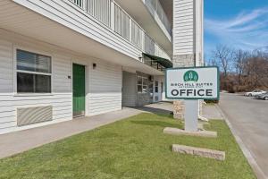 a sign for an office outside of a building at Birch Hill Suites Kansas City - Independence in Independence
