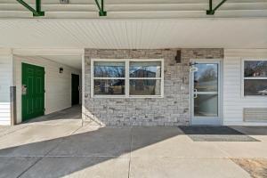 a front door of a house with a green door at Birch Hill Suites Kansas City - Independence in Independence