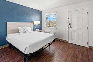 a large white bed in a room with a window at Birch Hill Suites Kansas City - Independence in Independence +19 photos