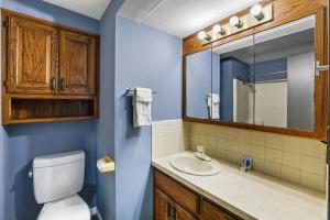 a bathroom with a toilet and a sink and a mirror at Grand Motel in Hastings +23 photos