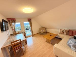 a living room with a couch and a table at Ferienhaus Frei 3 Budget in Titisee-Neustadt